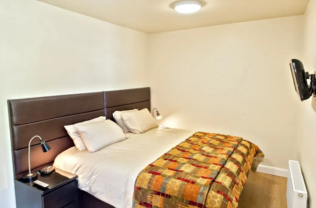 Crisp bed linen in a Swan apartment bedroom